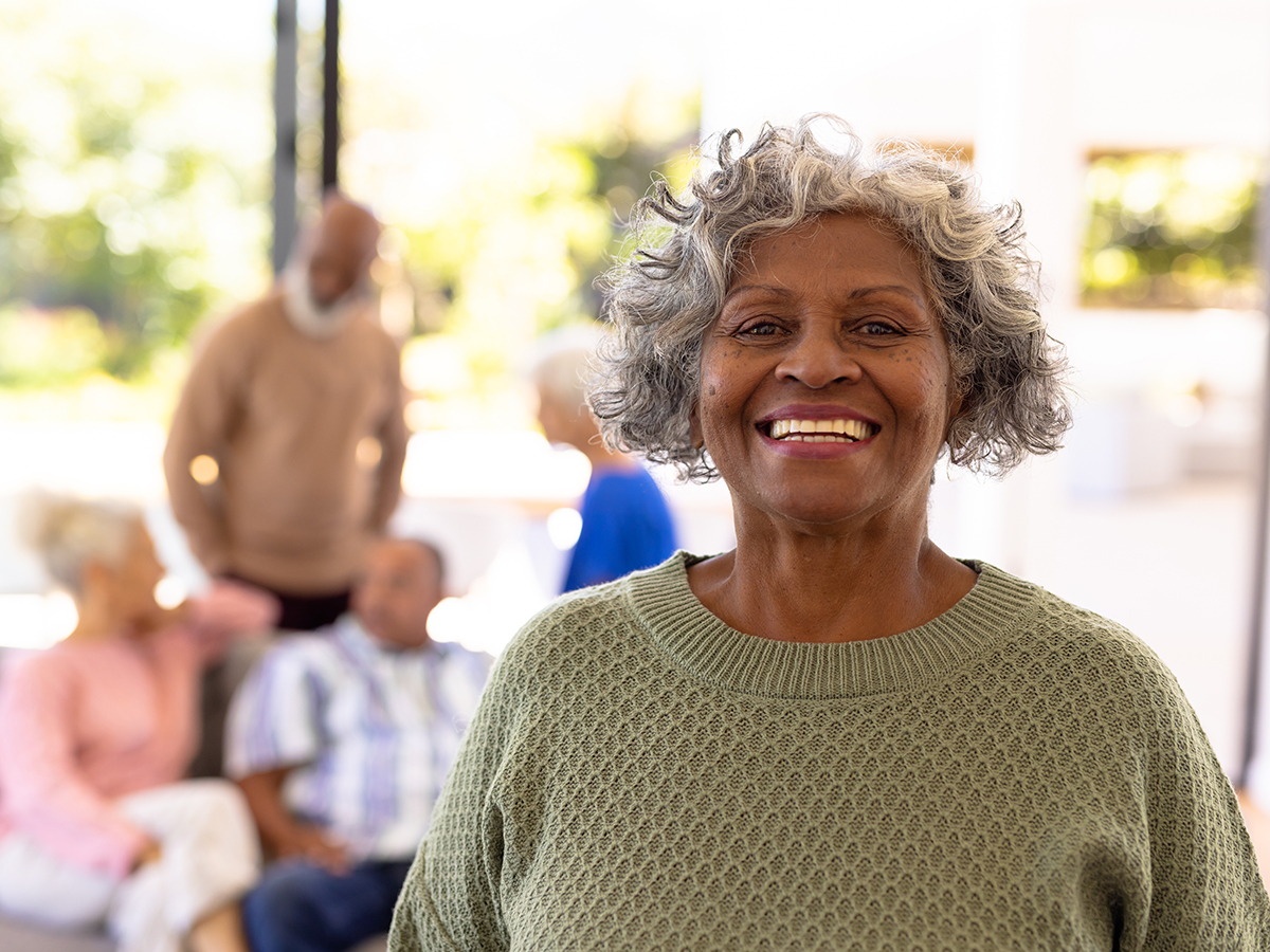 woman smiling with others in background