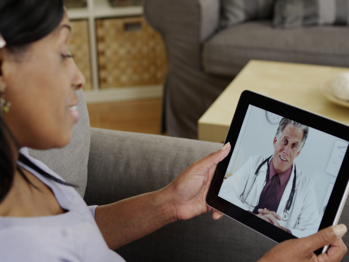 woman speaking with doctor on a tablet