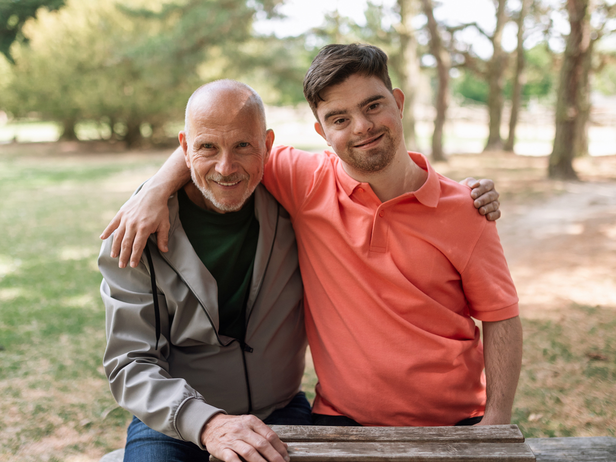 Older man with young adult son with Down Syndrome
