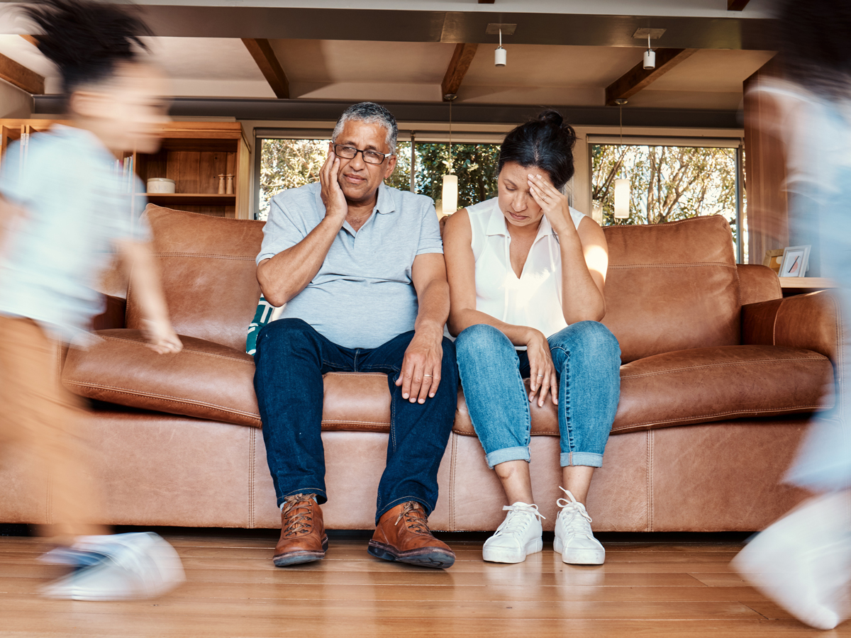 Grandparents watching children running in house