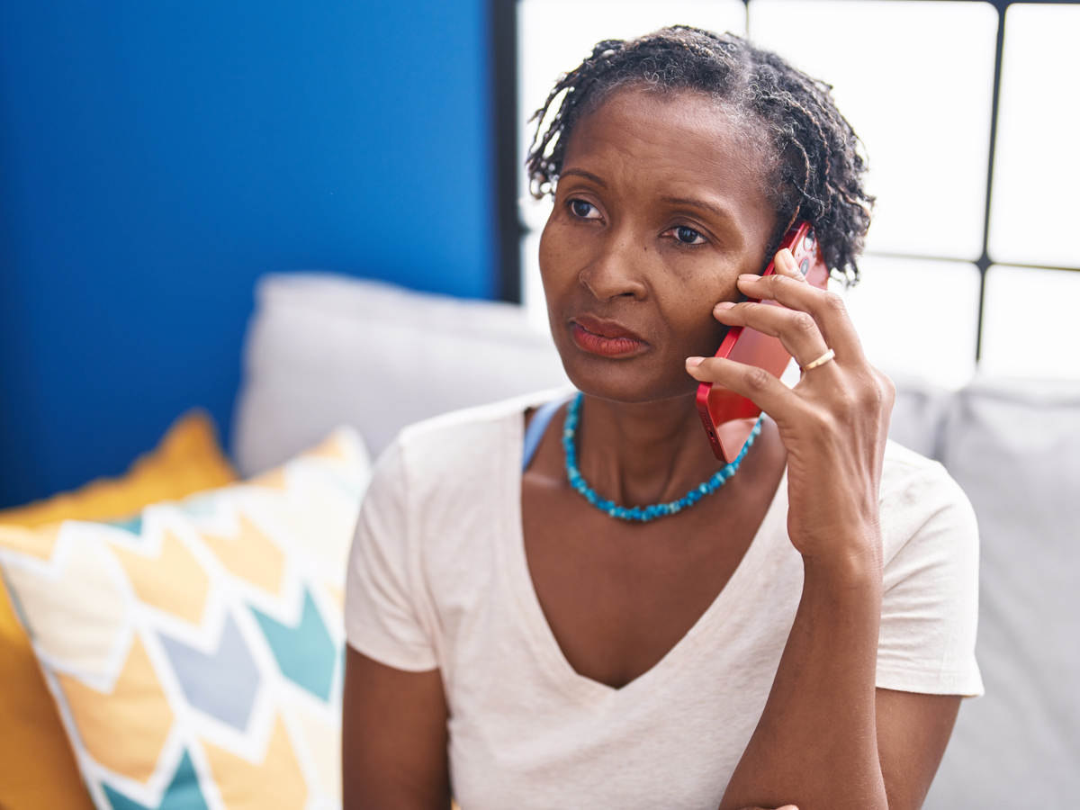 woman on phone looking distressed
