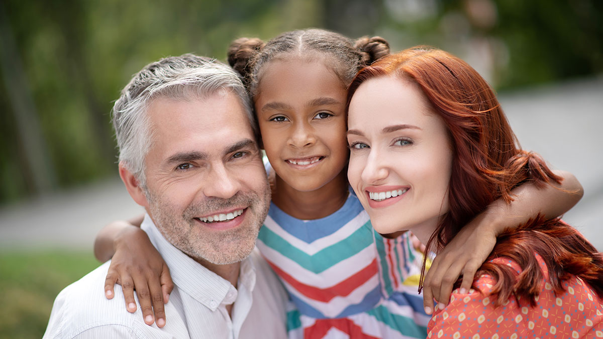 Child with her adoptive parents.