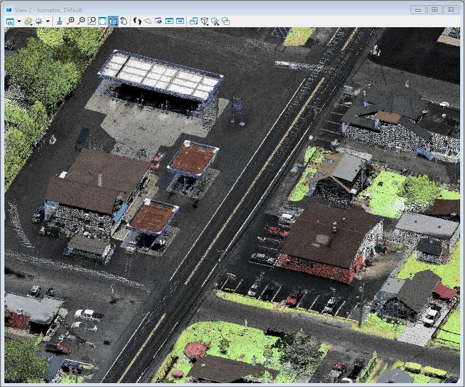 A drone-based LiDAR image, which is a tool to improve geospatial data collection, shows a two-lane roadway with large buildings and homes on either side of the roadway.