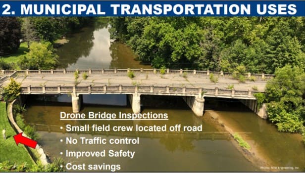 A screenshot of an aerial photo of a bridge over a waterway from a training that is highlighting different ways municipal governments can use drones in transportation.