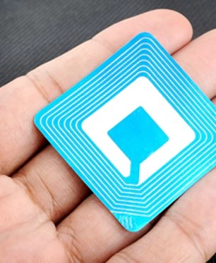 An image of a blue radio frequency identification (RFID) tag sitting in someone's hand.