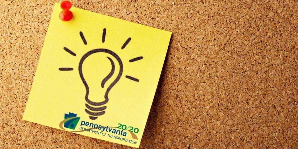 Lightbulb image on a yellow sticky note that is pinned to a corkboard.