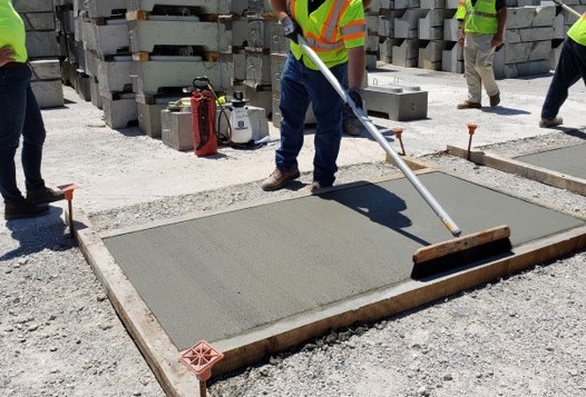 Certified Concrete Finishers Course participant finishing concrete.