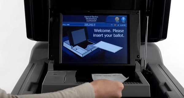 Person placing their ballot into the ballot scanner