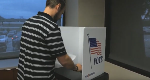 Person standing in a voting booth